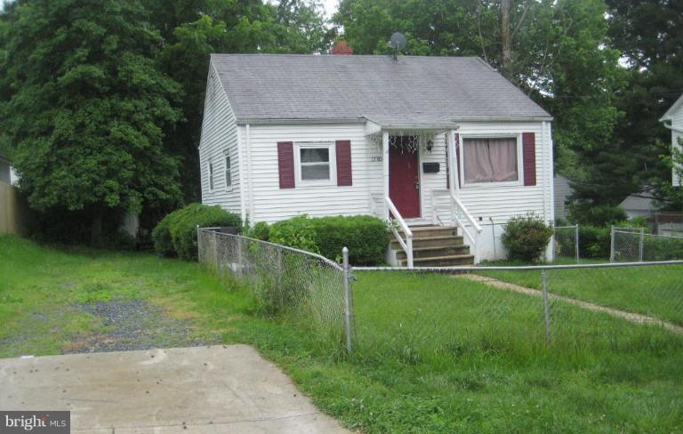 12310 Charles Road Silver Spring, MD 20906 - Photo 1 of 14 a front view of a house with a garden