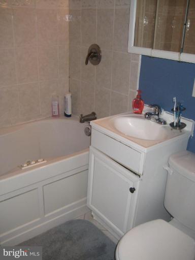 12310 Charles Road Silver Spring, MD 20906 - Photo 11 of 14 a bathroom with a sink toilet vanity and tub