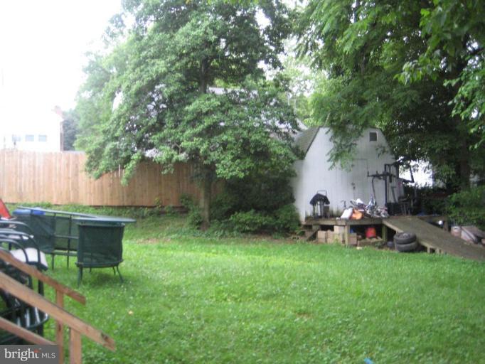 12310 Charles Road Silver Spring, MD 20906 - Photo 13 of 14 a view of a backyard with wooden fence and a bench