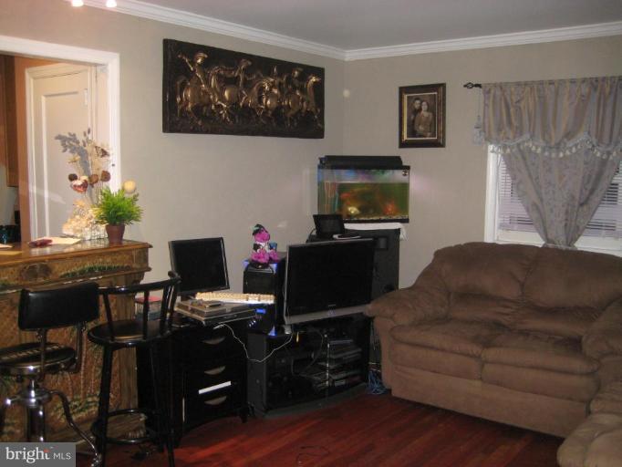 12310 Charles Road Silver Spring, MD 20906 - Photo 3 of 14 a living room with furniture and a flat screen tv