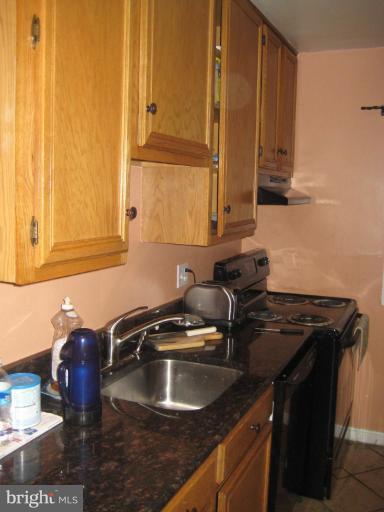 12310 Charles Road Silver Spring, MD 20906 - Photo 5 of 14 a kitchen with a sink and cabinets