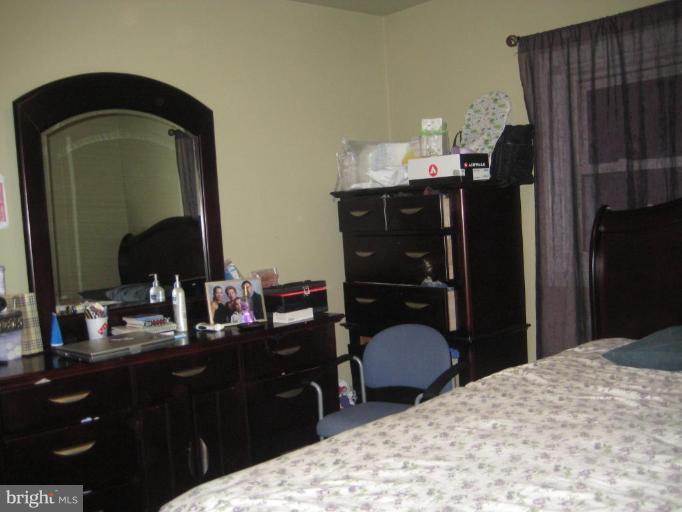 12310 Charles Road Silver Spring, MD 20906 - Photo 10 of 14 a bedroom with a bed and a mirror