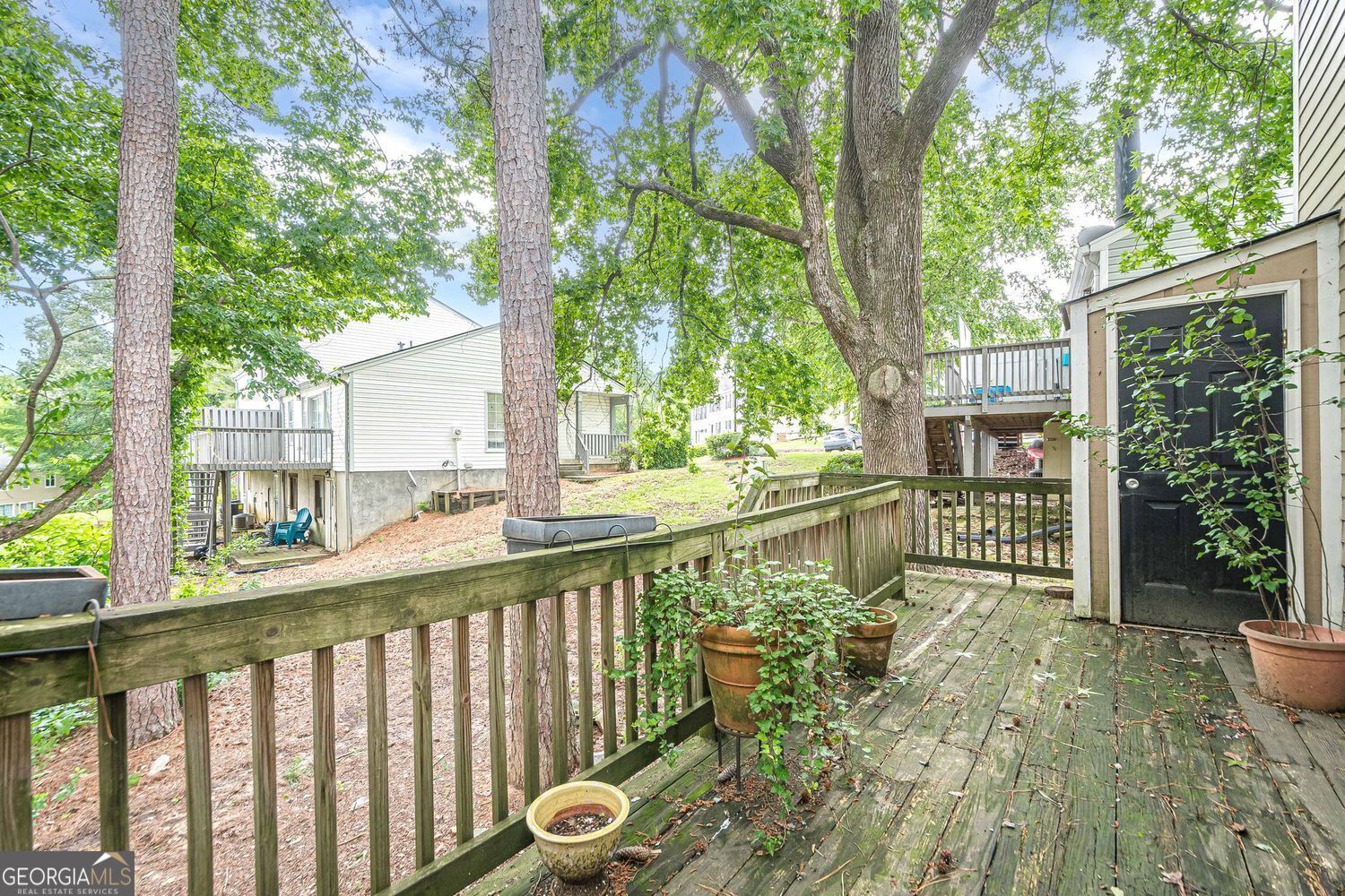 3403 Spring Harbor Lane Doraville, GA 30340 - Photo 21 of 27 a view of a house with a small yard and large trees