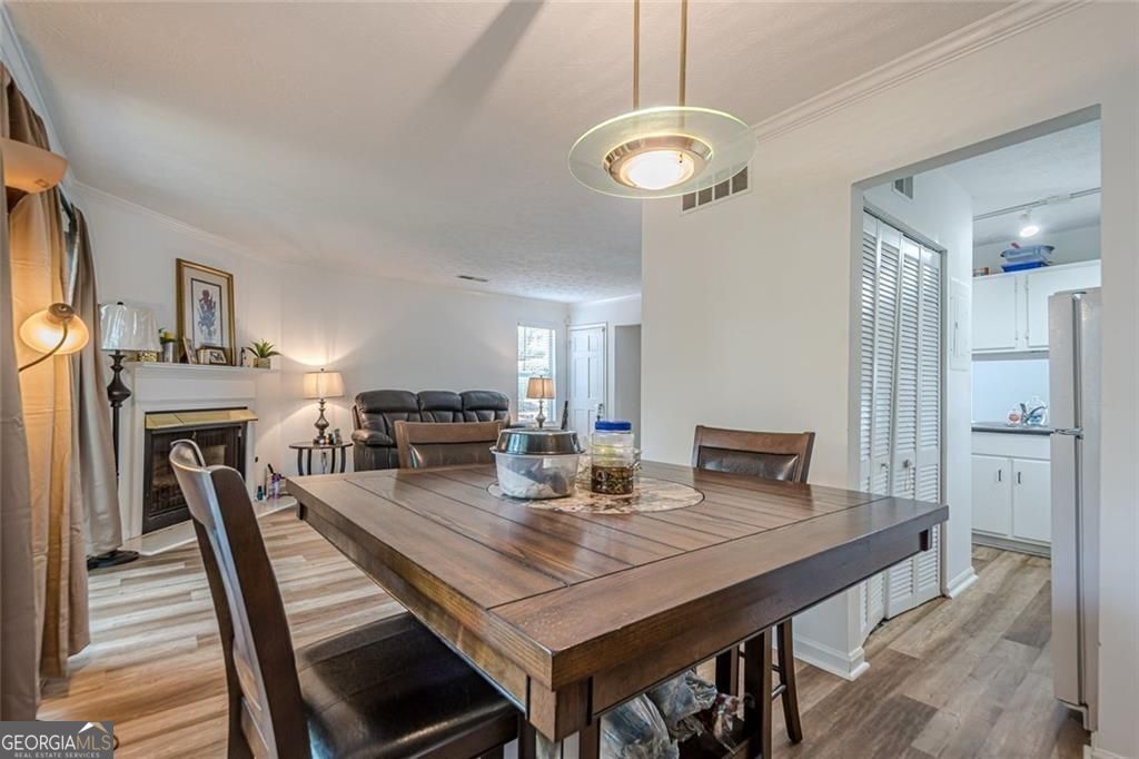 3403 Spring Harbor Lane Doraville, GA 30340 - Photo 4 of 27 a view of a dining room with furniture a fireplace and wooden floor