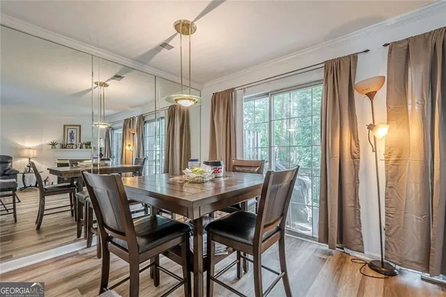 a view of a dining room with furniture window and wooden floor