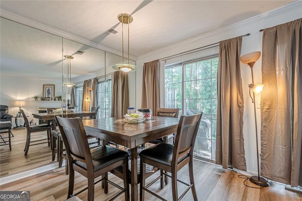 3403 Spring Harbor Lane Doraville, GA 30340 - Photo 5 of 27 a view of a dining room with furniture window and wooden floor