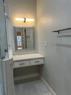 an empty room with windows and fireplace