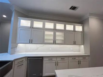 a stove top oven sitting inside of a kitchen
