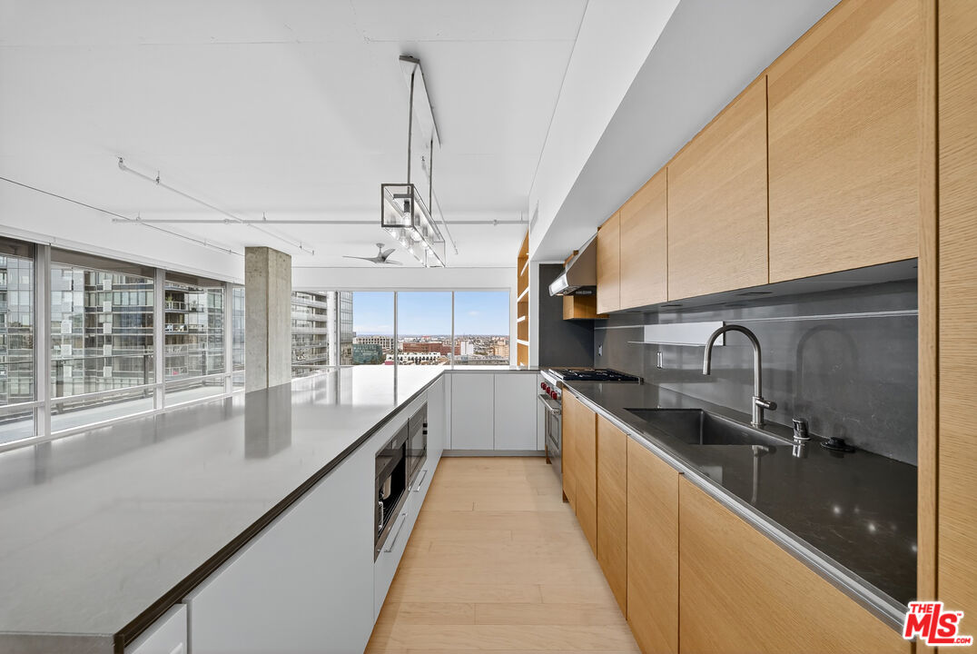 1100 South Hope Street, Unit 1501 Los Angeles, CA 90015 - Photo 15 of 63 a large white kitchen with a large window