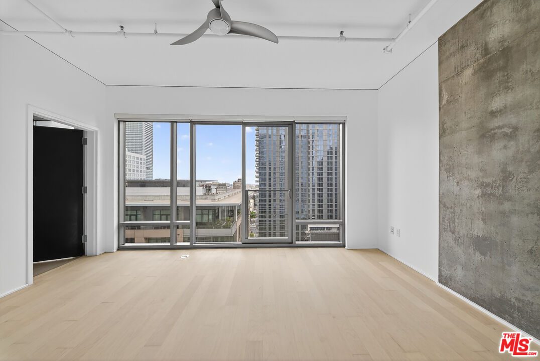 1100 South Hope Street, Unit 1501 Los Angeles, CA 90015 - Photo 20 of 63 a view of an empty room with a sliding door