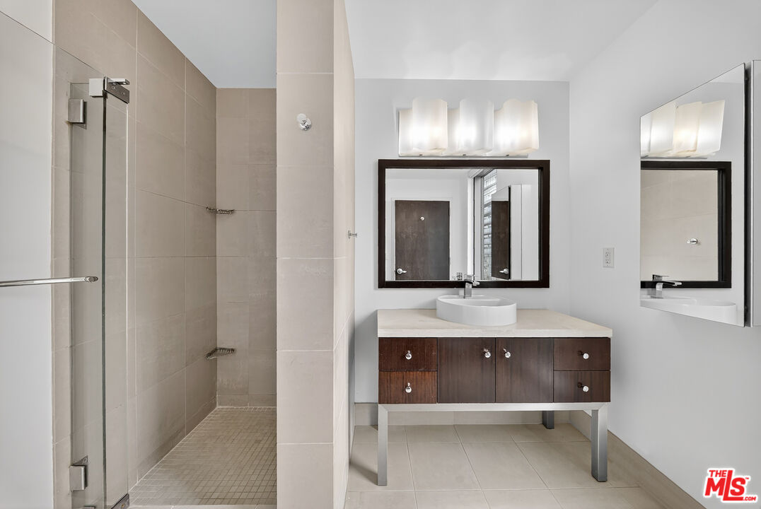 1100 South Hope Street, Unit 1501 Los Angeles, CA 90015 - Photo 24 of 63 a bathroom with a sink and a mirror