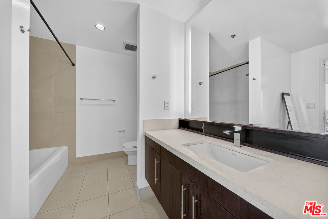 1100 South Hope Street, Unit 1501 Los Angeles, CA 90015 - Photo 30 of 63 a bathroom with a sink and a mirror