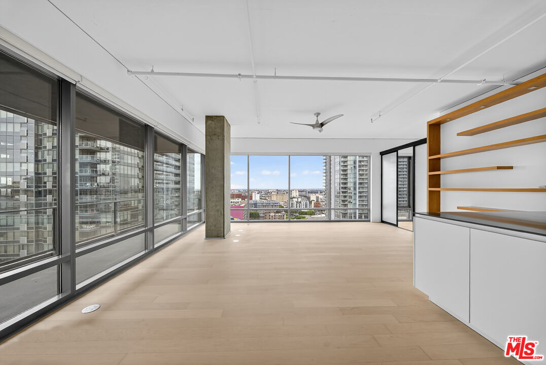 1100 South Hope Street, Unit 1501 Los Angeles, CA 90015 - Photo 32 of 63 a view of an empty room with a sliding door