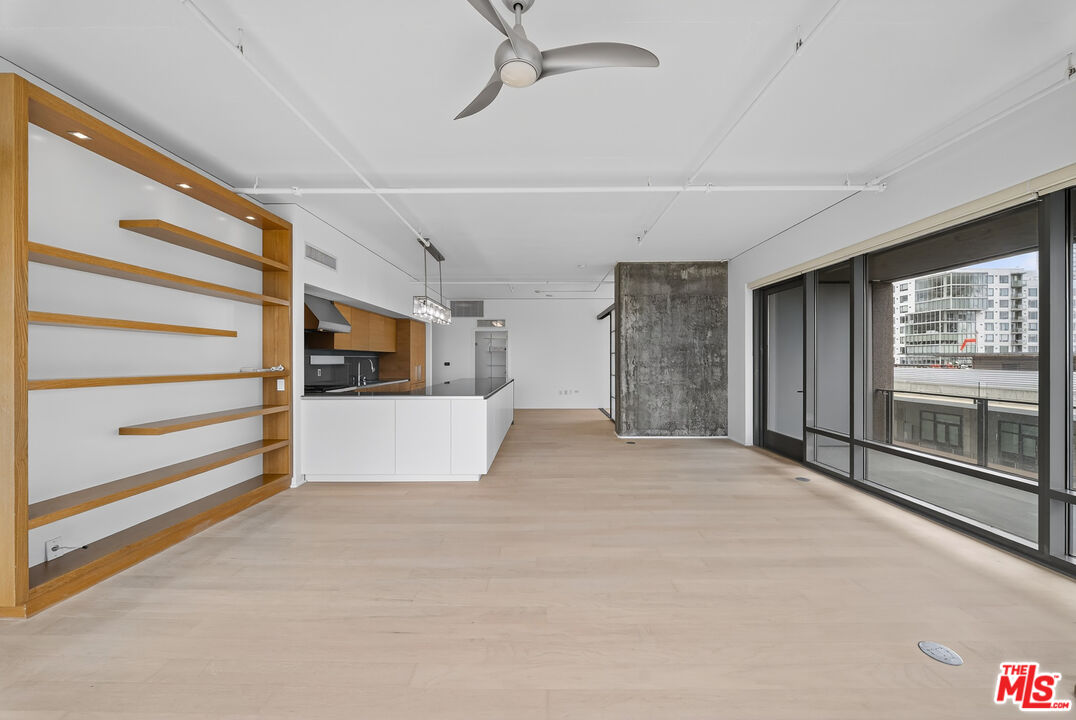 1100 South Hope Street, Unit 1501 Los Angeles, CA 90015 - Photo 35 of 63 a view of an empty room with a fireplace and a window
