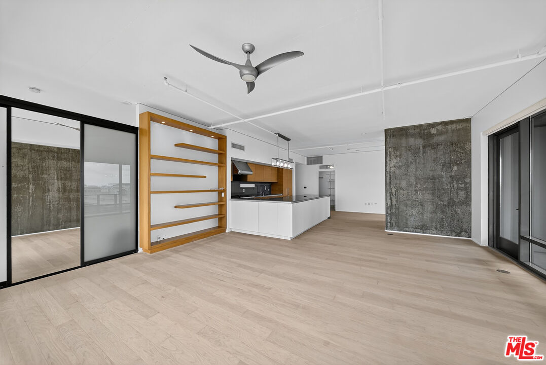 1100 South Hope Street, Unit 1501 Los Angeles, CA 90015 - Photo 37 of 63 a view of an empty room with closet and a ceiling fan