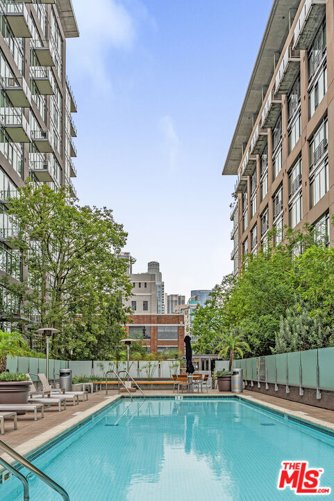 1100 South Hope Street, Unit 1501 Los Angeles, CA 90015 - Photo 59 of 63 a view of swimming pool with outdoor seating and lake view