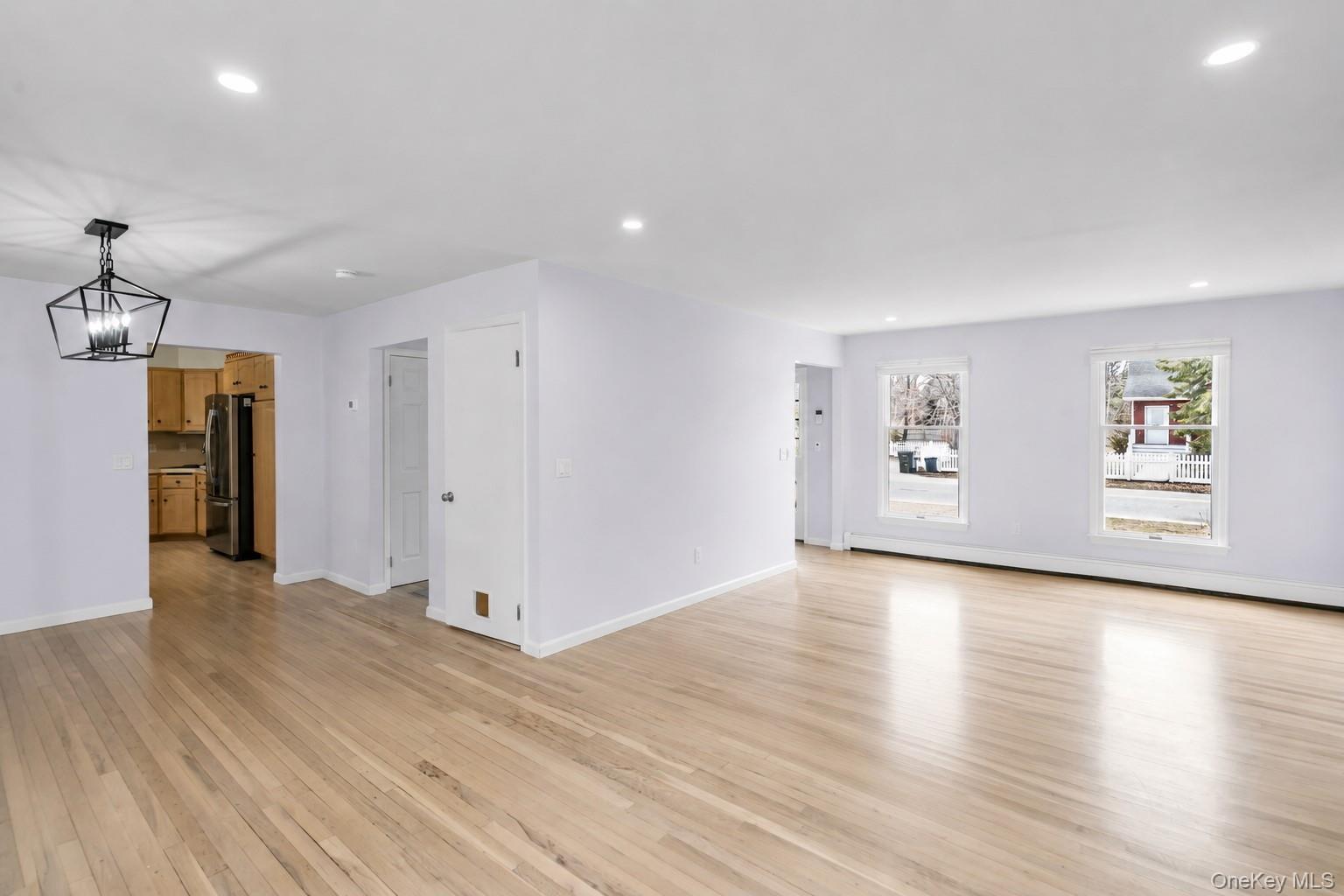 5845 North Bayview Road Southold, NY 11971 - Photo 4 of 26 Expansive living area with large windows, plenty of natural light, hardwood flooring and a formal dining area