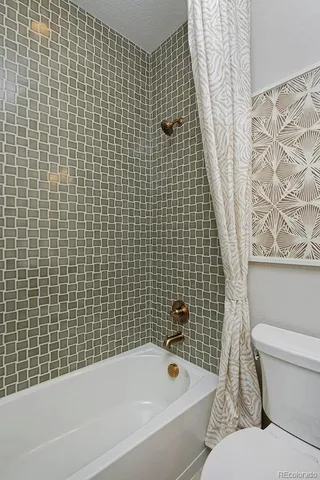 a bathroom with a bathtub and a toilet