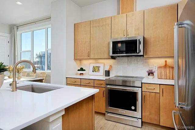 a kitchen with a sink stove and microwave