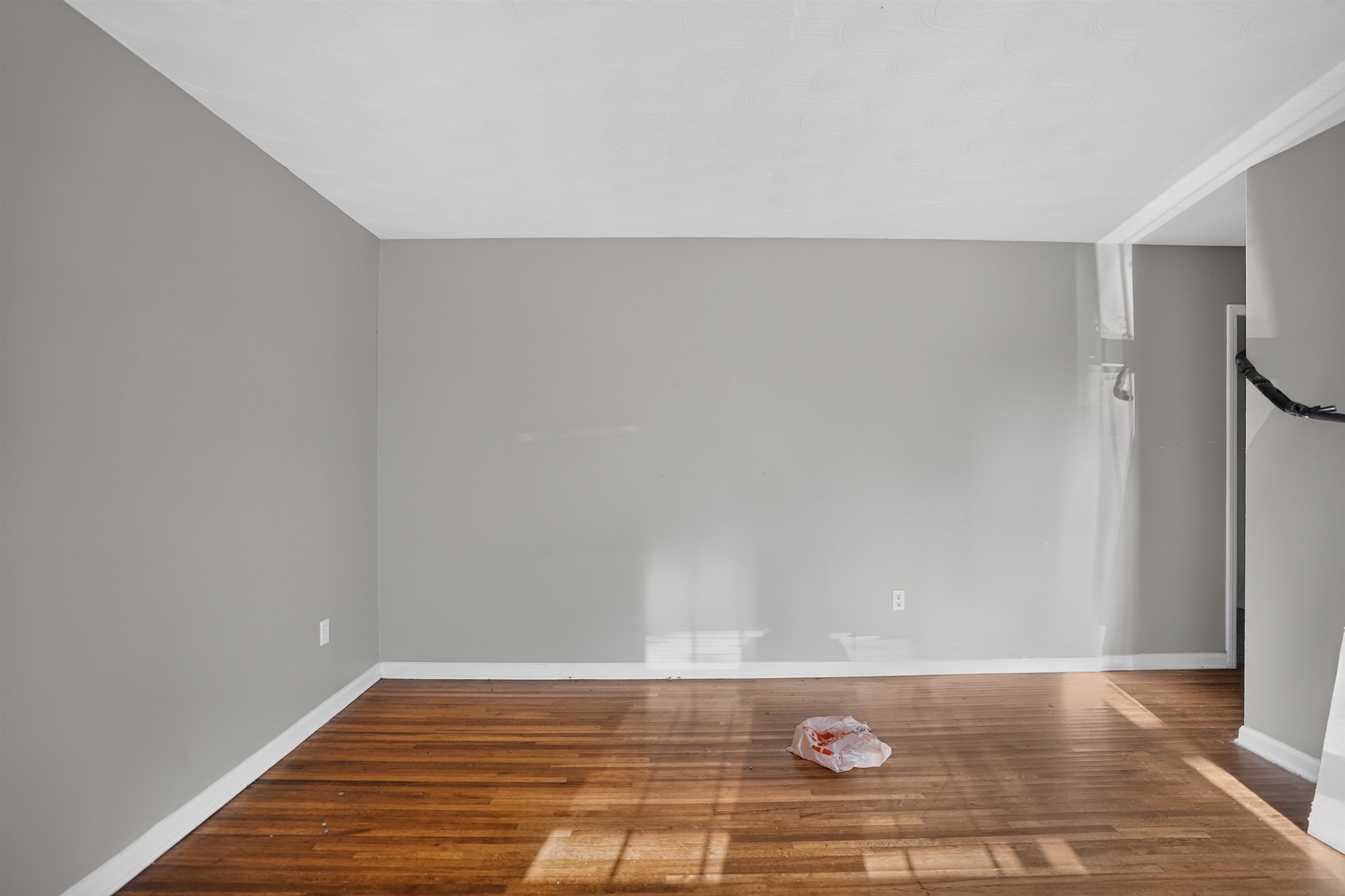 3736 Range Line Road Memphis, TN 38127 - Photo 15 of 18 Interior space featuring wood-finish flooring, light gray wall paint, white trim, and a white ceiling