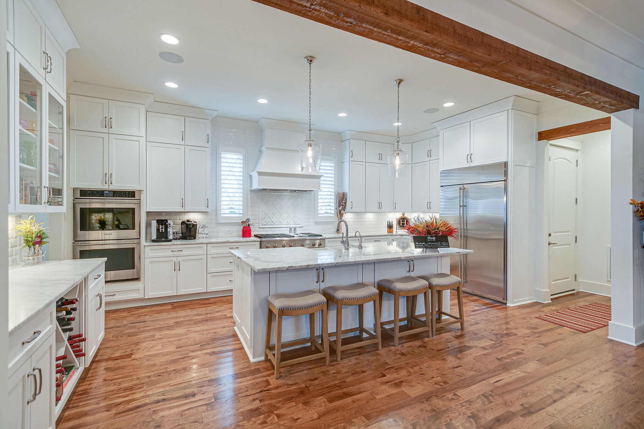 8448 Heirloom Boulevard College Grove, TN 37046 - Photo 16 of 41 a kitchen with stainless steel appliances granite countertop a table chairs sink refrigerator and cabinets
