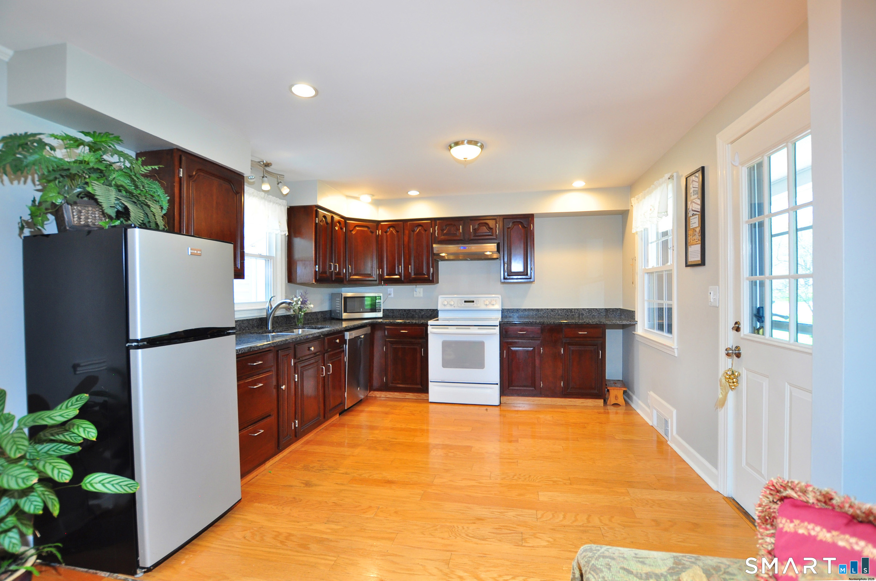 36 Pilgrim Drive Windsor, CT 06095 - Photo 6 of 33 a large kitchen with stainless steel appliances kitchen island granite countertop a refrigerator and a sink