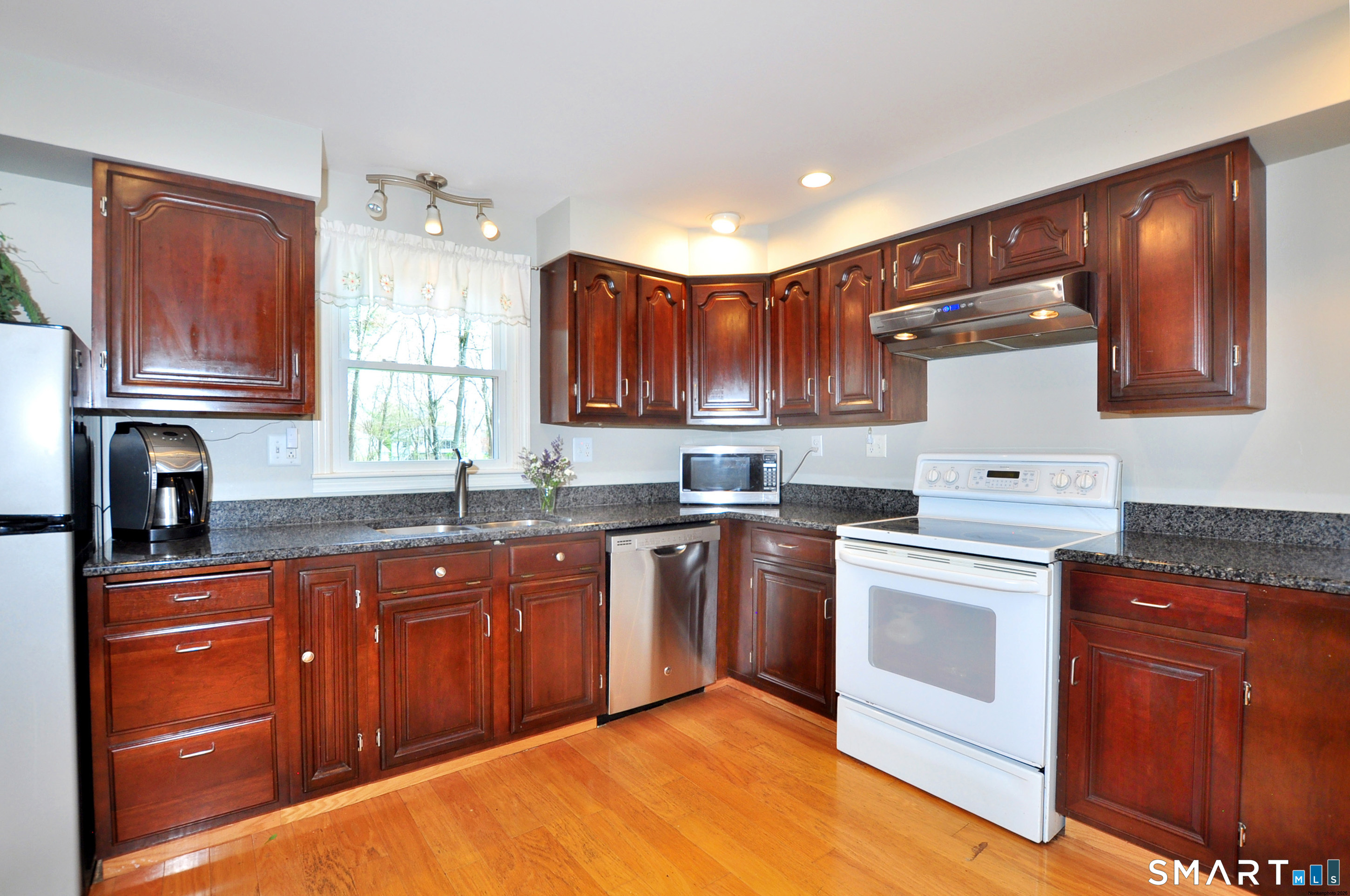 36 Pilgrim Drive Windsor, CT 06095 - Photo 8 of 33 a kitchen with granite countertop wooden cabinets stainless steel appliances and a window