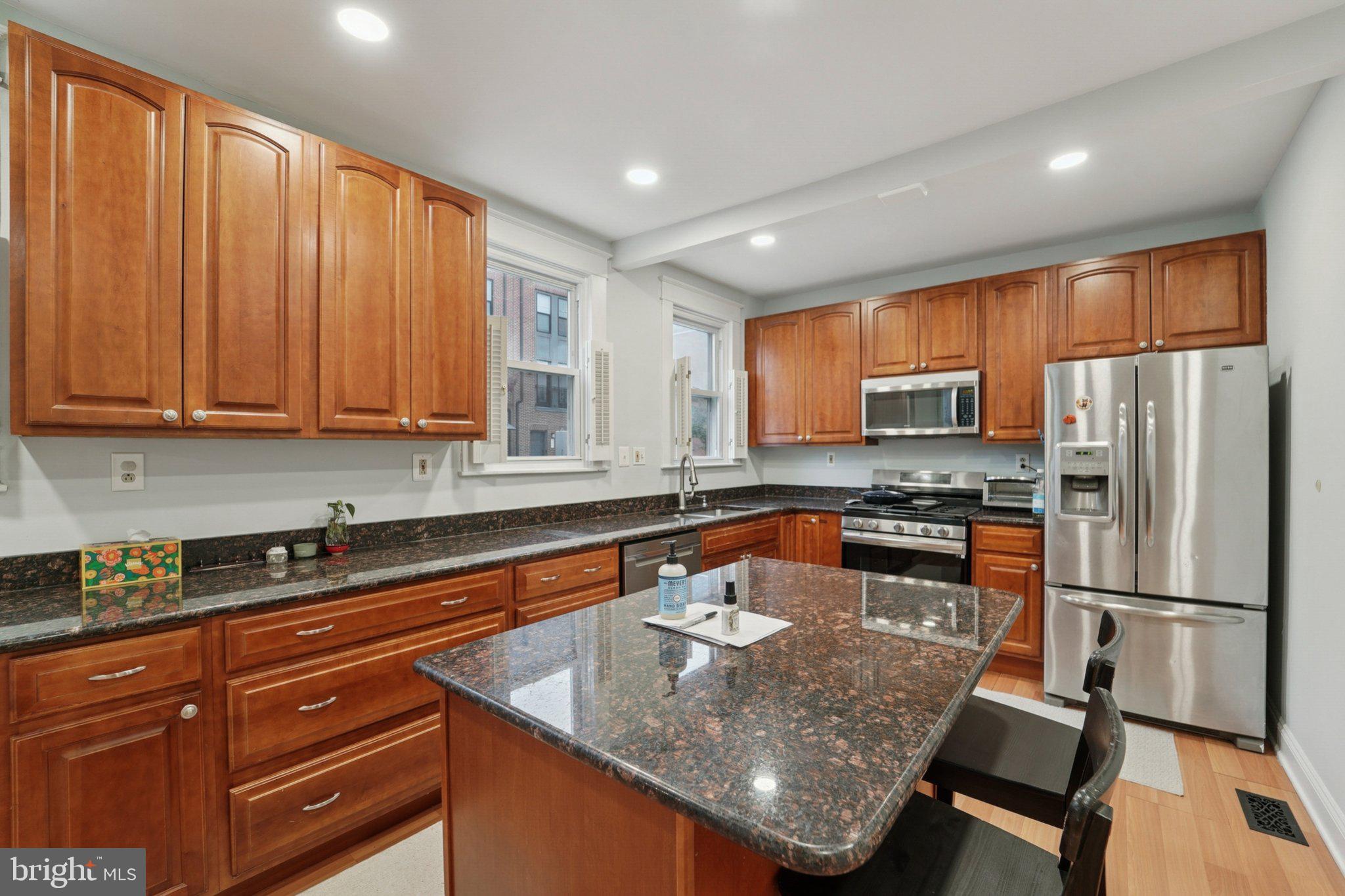 3929 Hudson Street Baltimore, MD 21224 - Photo 13 of 48 a kitchen with stainless steel appliances granite countertop a sink a stove and refrigerator
