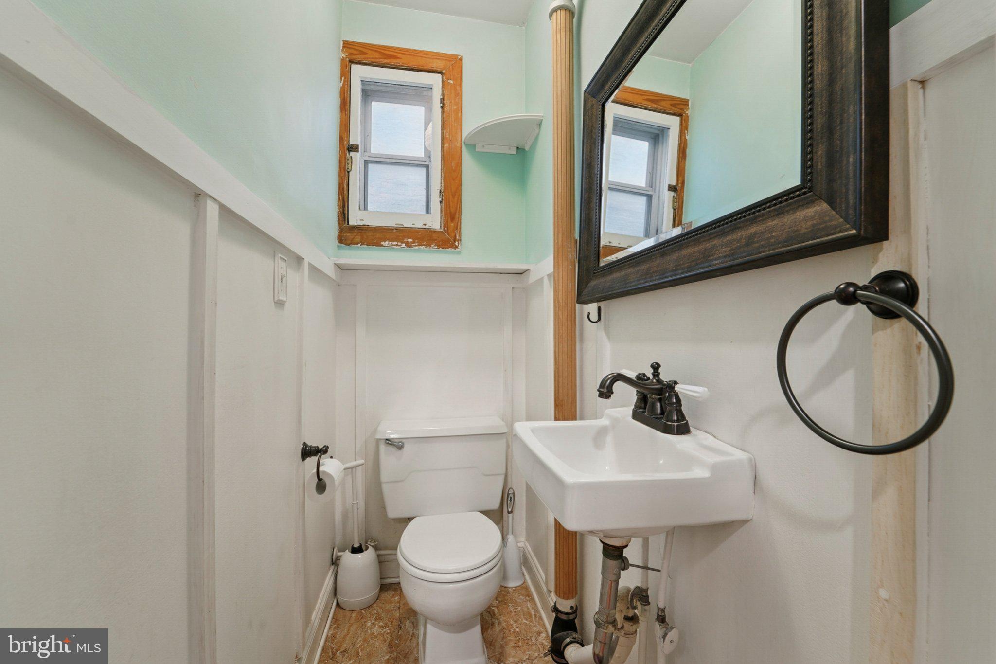 3929 Hudson Street Baltimore, MD 21224 - Photo 25 of 48 a bathroom with a toilet sink and mirror