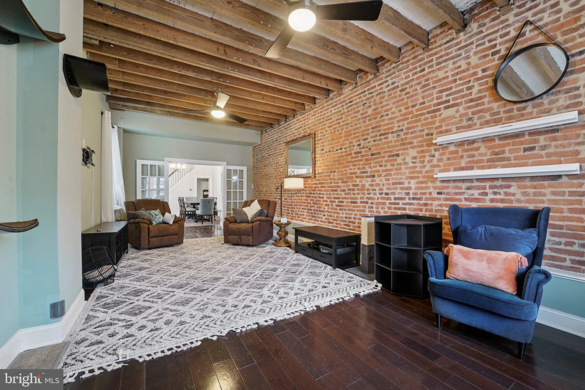 3929 Hudson Street Baltimore, MD 21224 - Photo 6 of 48 a living room with furniture a rug and a fireplace