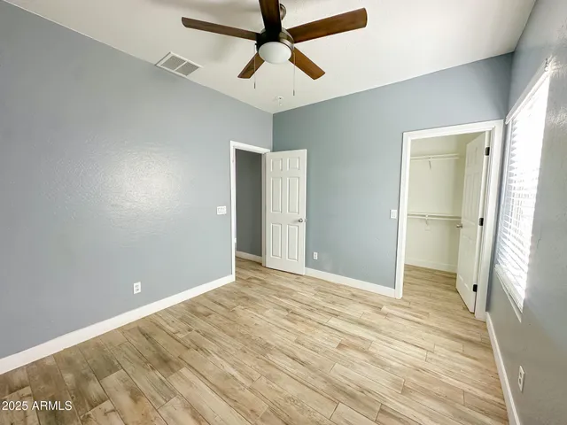 a view of an empty room with wooden floor