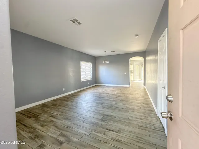 a view of a room with wooden floor and window