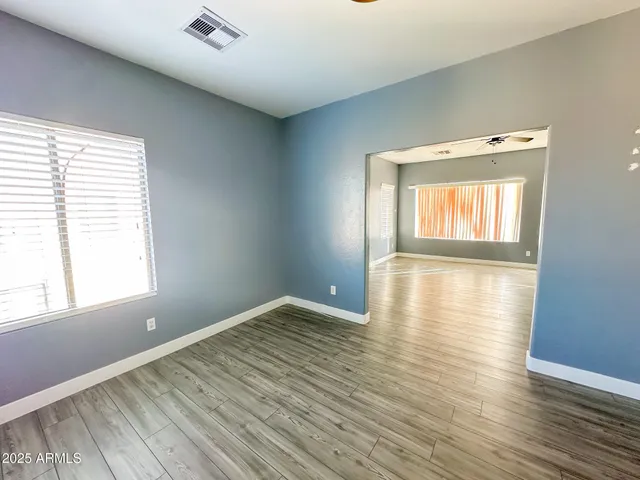 a view of a room with wooden floor