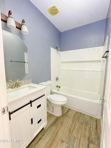a view of a big room with wooden floor closet and windows