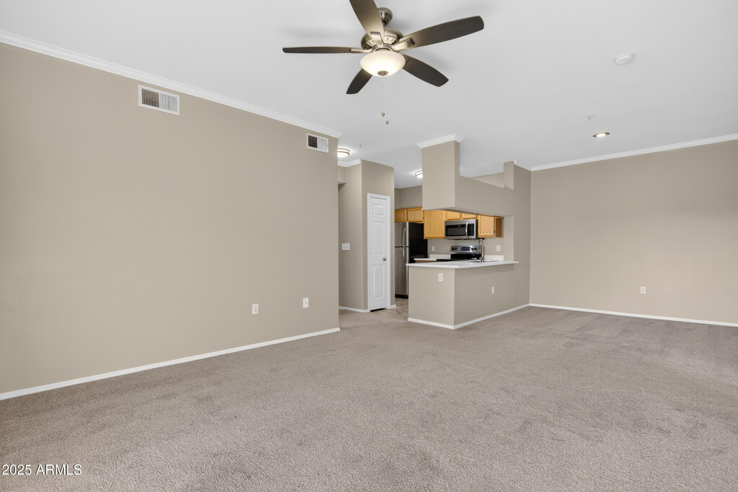 5401 East Van Buren Street, Unit 2022 Phoenix, AZ 85008 - Photo 11 of 37 a view of a kitchen with a sink and a refrigerator