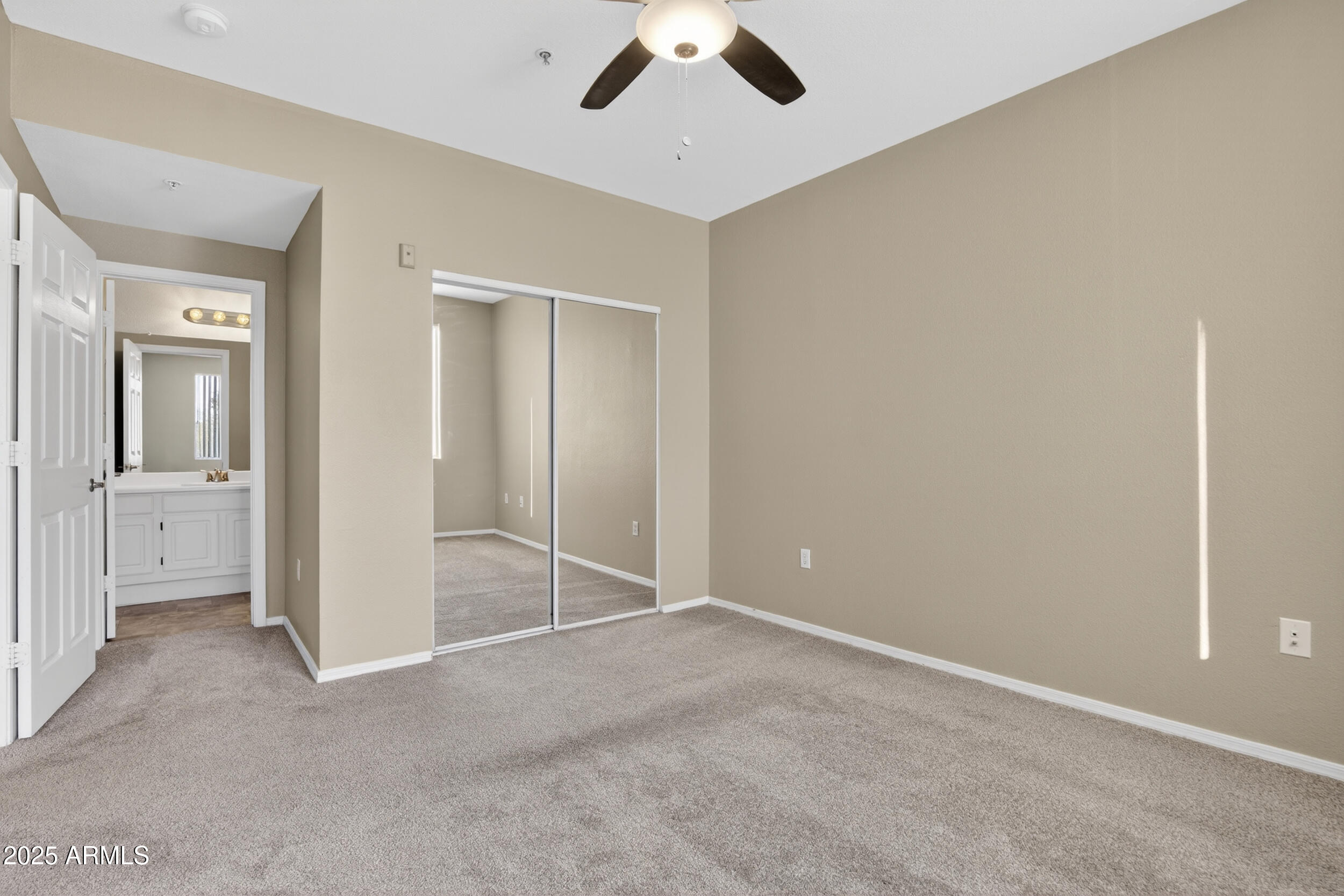 5401 East Van Buren Street, Unit 2022 Phoenix, AZ 85008 - Photo 15 of 37 an empty room with chandelier fan