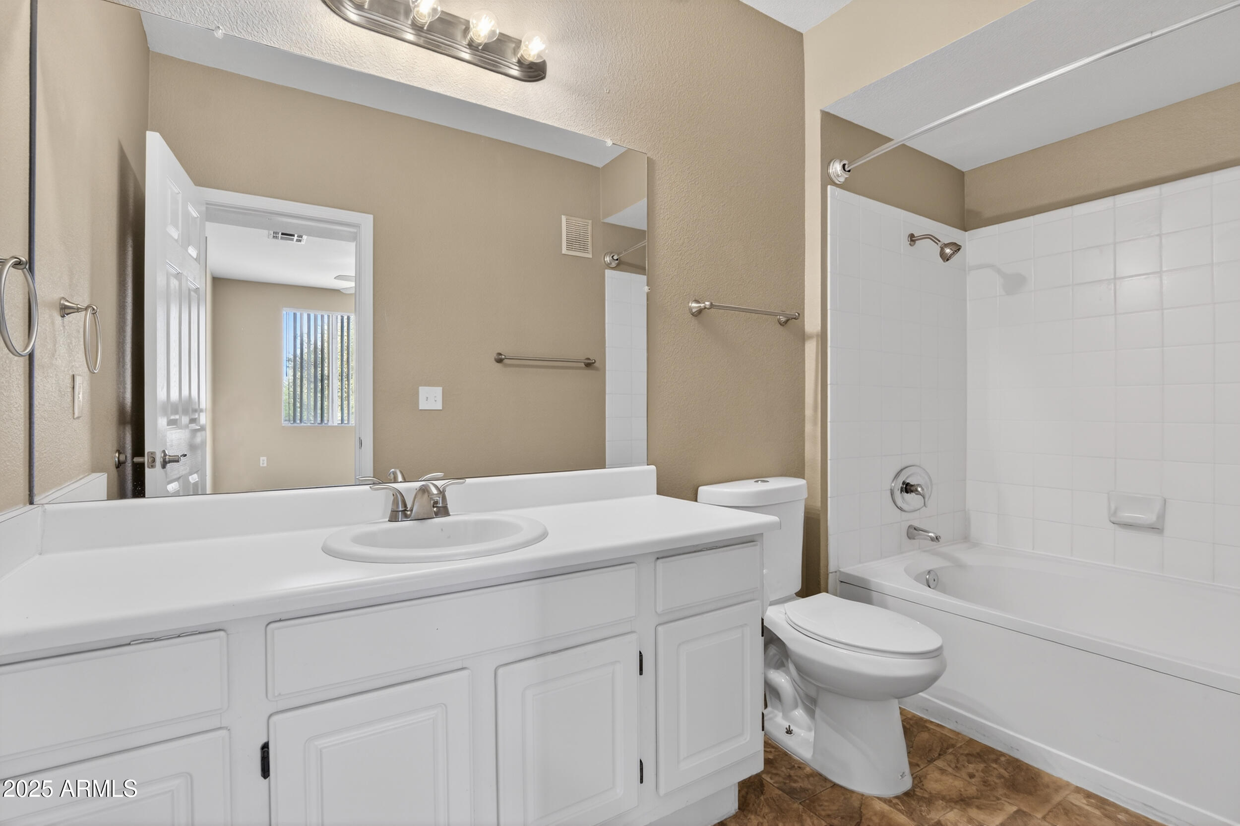 5401 East Van Buren Street, Unit 2022 Phoenix, AZ 85008 - Photo 16 of 37 a bathroom with a sink a toilet and shower