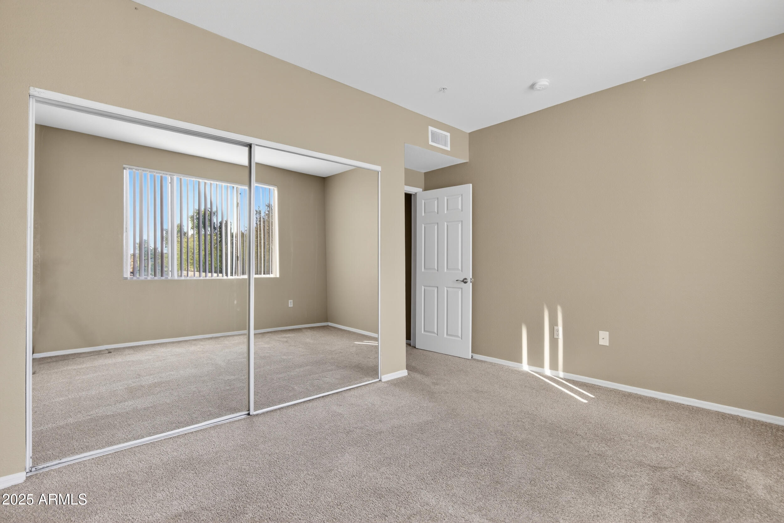 5401 East Van Buren Street, Unit 2022 Phoenix, AZ 85008 - Photo 18 of 37 a view of an empty room with window and chandelier fan