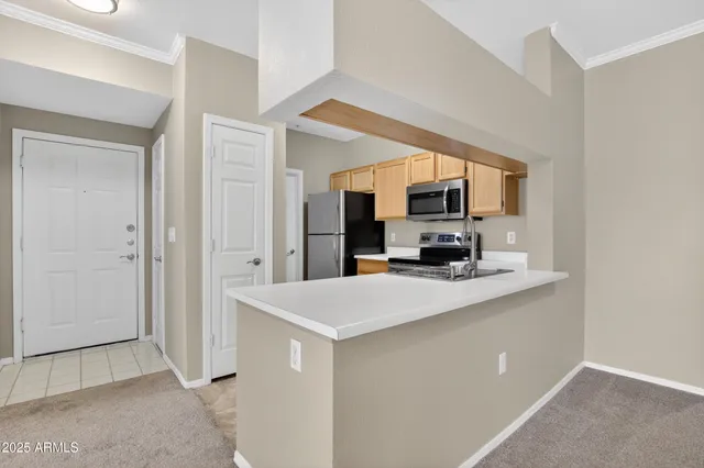 a kitchen with granite countertop a refrigerator stove and microwave