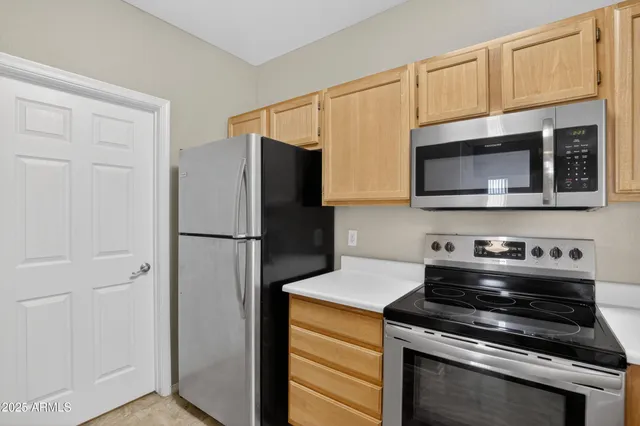 a kitchen with stainless steel appliances granite countertop a stove microwave and sink