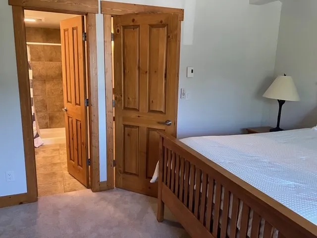 a bedroom with a bed and a mirror