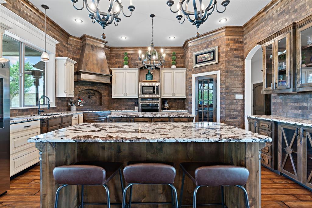 12190 Marion Road Sanger, TX 76266 - Photo 16 of 39 a kitchen with stainless steel appliances granite countertop a sink table and chairs