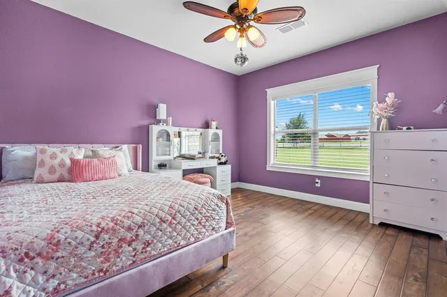 a bedroom with a bed dresser and a window