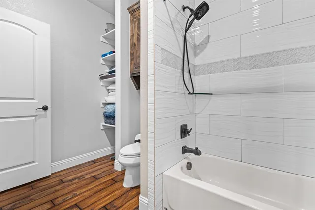 a bathroom with a bathtub and shower