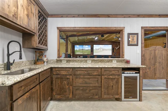 a bathroom with a granite countertop sink a large mirror and a window