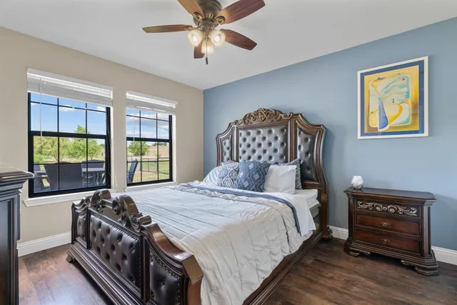 a bedroom with a bed and a tv on the dresser