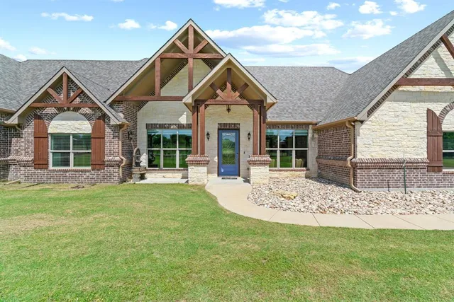 a view of a house with a yard and porch