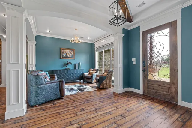 a living room with furniture and a chandelier