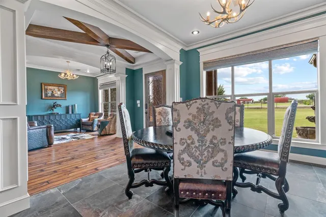 a living room with patio furniture and a floor to ceiling window