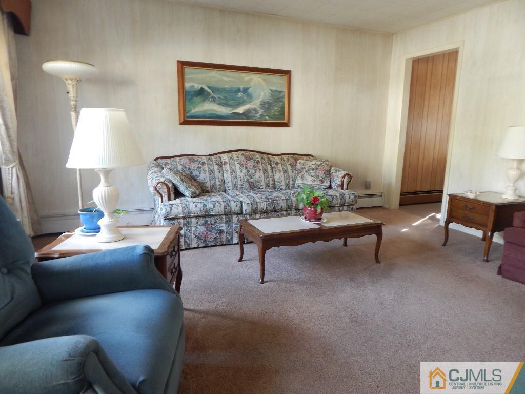 11 Dobson Road Edison, NJ 08817 - Photo 2 of 16 a living room with furniture and a lamp